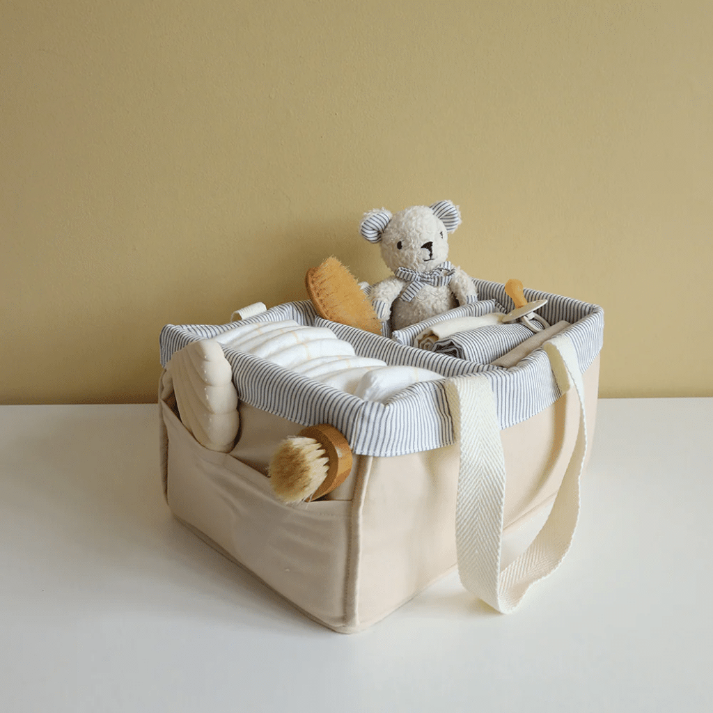 a basket with a teddy bear and other items. cam cam Pusleopbevaring - OCS - Classic Stripes Blue