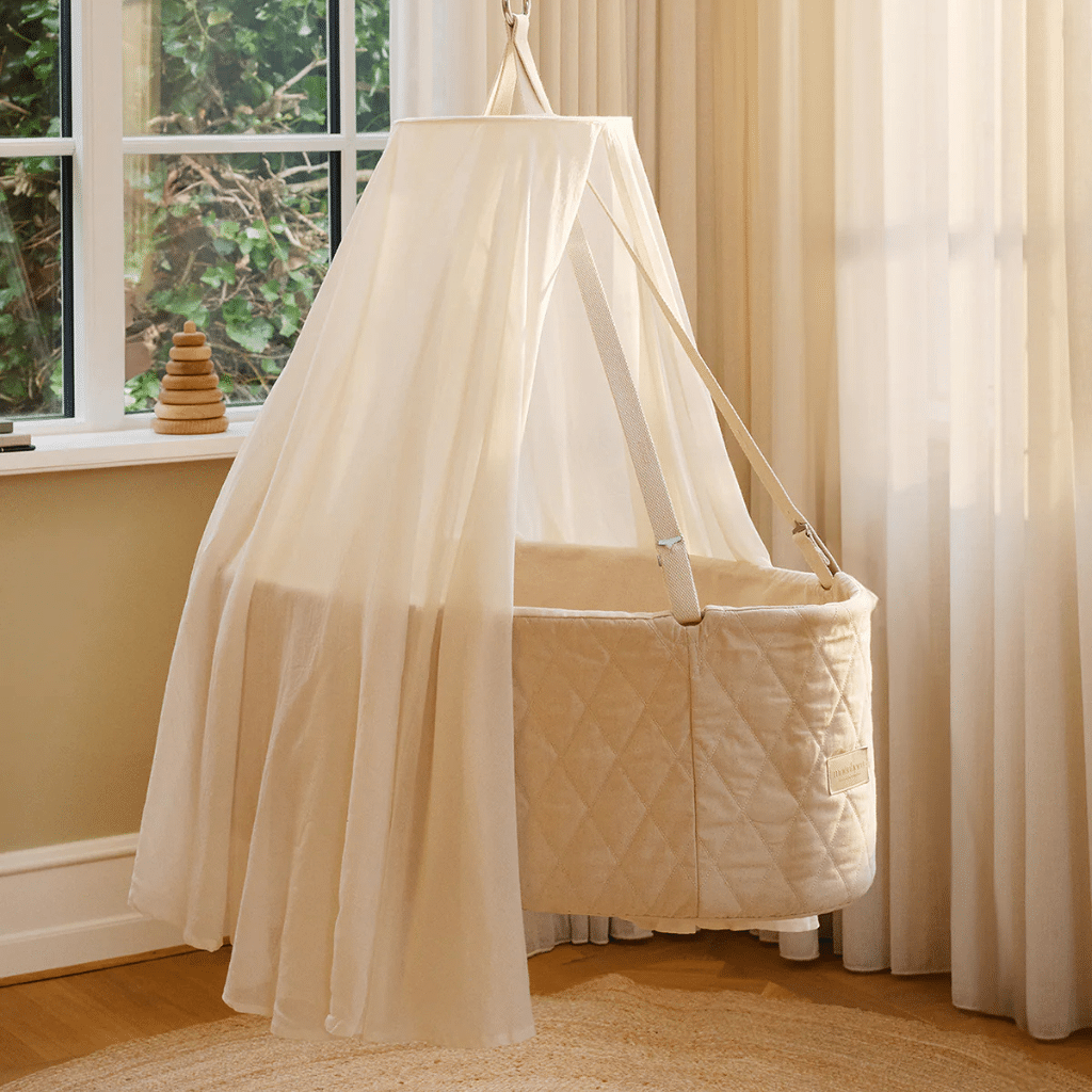 a round crib with a white canopy. moonboon heaven